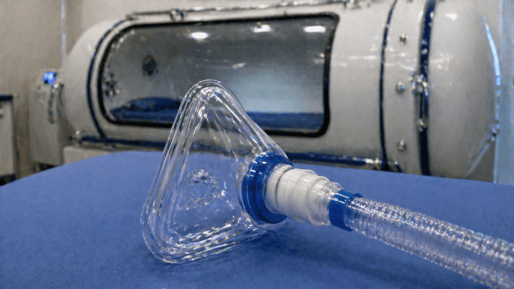 An oxygen mask with a hyperbaric chamber in the background